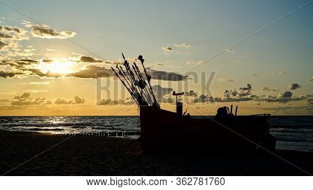 Fishing Boat At Sunset On The Beach Of The Baltic Sea Near Rewal In Poland