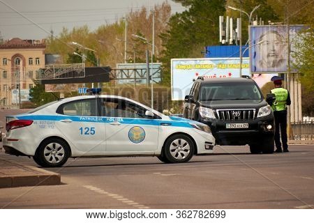 Karaganda, Kazakhstan - 23nd April, 2020: Patrol Officers Check Cars And Documents With Drivers Duri
