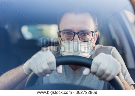 Close Up Of Driver In Protective Mask With Hands In Rubber Gloves On Steering Wheel, Covid-19 Protec