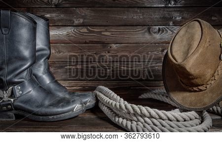 Cowboy Hat, Boots And Rope On Wooden Background