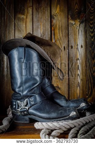 Cowboy Hat, Boots And Rope On Wooden Background