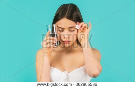 Young Woman Taking Pill Against Headache. Brunette Taking A Pill With A Glass Of Water. Woman Taking