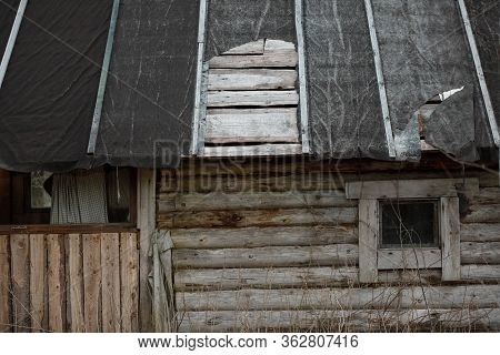 Torn Ruberoid Roofing Material On The Roof Of The House