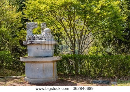 Jinan, South Korea; April 21, 2020: Concrete Water Fountain Topped With Sculpted Dragons In Public P