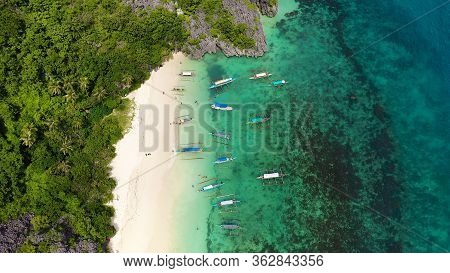 Tropical Beach With Tourists Surrounded By Blue Water, Aerial View. Lahos Island, Caramoan Islands, 