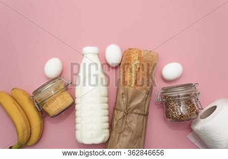 Donation Food. Corn, Buckwheat In Jar, Bananas, Milk, Bread, Bananas On Pink Background.
