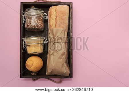 Donation Food. Corn, Buckwheat In Jar, Bananas, Milk, Bread, Bananas On Pink Background.