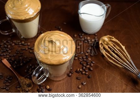 Cold Dalgon Coffee In Clear Glasses On A Dark Wooden Background. Foam From Sugar And Instant Coffee