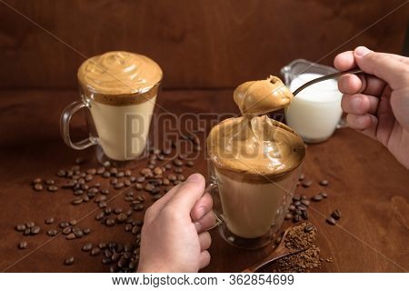 Cold Dalgona Coffee In Clear Glasses On A Dark Wooden Background. Froth Of Sugar And Instant Coffee