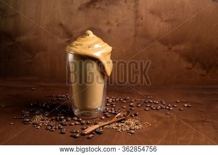 Cold Dalgon Coffee In Clear Glasses On A Dark Wooden Background. Foam From Sugar And Instant Coffee