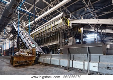 Grodno, Belarus - October 2018: Recycling Plant Conveyor Belt Transports Garbage Inside Drum Filter 