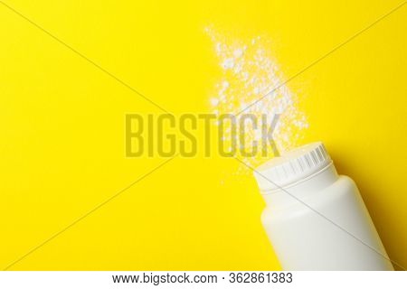 Blank Bottle Of Talcum Powder On Yellow Background, Space For Text