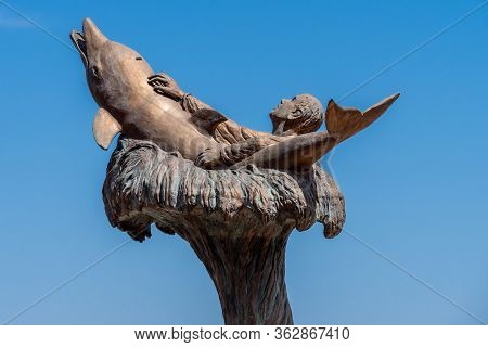 Porto Santo Stefano, Grosseto, Tuscany, Italy, April 2018: Monument To The Fallen Of The Sea, Dolphi