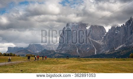 Alpe Di Siusi, Italy, October 18 2019: People Walking And Enjoying The Scenery Of Dolomite Rocky Mou