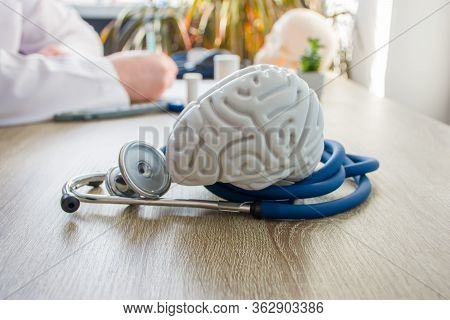 Concept Photo Of Diagnosis And Treatment Of Brain Nervous. In Foreground Is Model Of Brain Near Stet