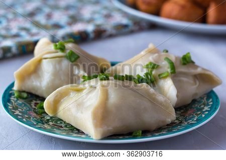 National Cuisine - Uzbek Manti With Meat In A Plate With A Traditional Pattern On The Table. Dastark