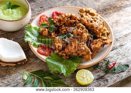 Indian Cuisine. Pakora Traditional Indian Deep-fried Snack. Pakoras On Black Plate With Coconut Chut