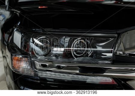 Headlight Of Modern Prestigious Black Car Close Up. Close Up Photo Of Modern Car, Detail Of Headligh