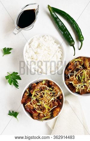 Spicy Garlic Fried Chicken (kkanpunggi). Asian Chicken In Sweet And Sour Sauce In Bowl Over White Ba
