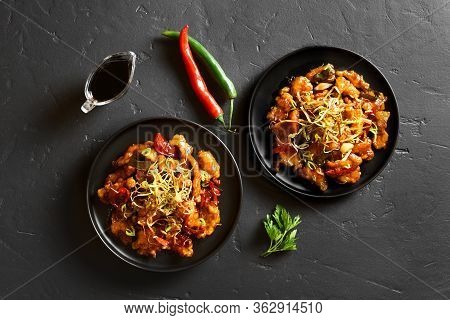 Spicy Garlic Fried Chicken (kkanpunggi). Asian Chicken In Sweet And Sour Sauce On Plate Over Black S