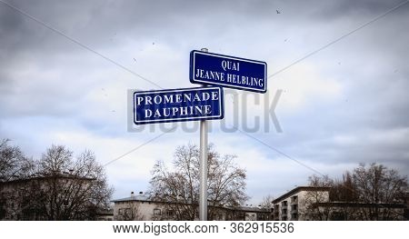 Blue Street Sign Where It Is Written In French Quai (dock) Jeanne Helbling And Promenade Dauphine In