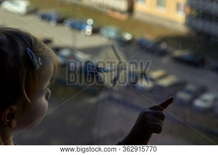 Girl Looks Lonely Through Window By Putting Her Hands On Window Sill