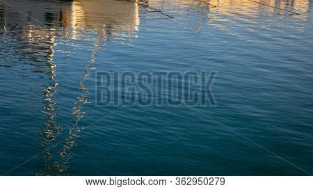 Reflections Of Boats In The Harbor On Sea Water