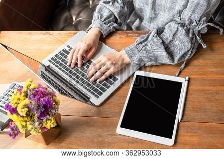Business Woman Working At Home With Her Laptop And Tablat.
