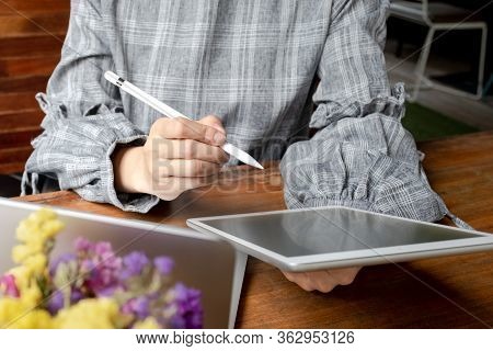 Business Woman Working At Home With Her Laptop And Tablat.