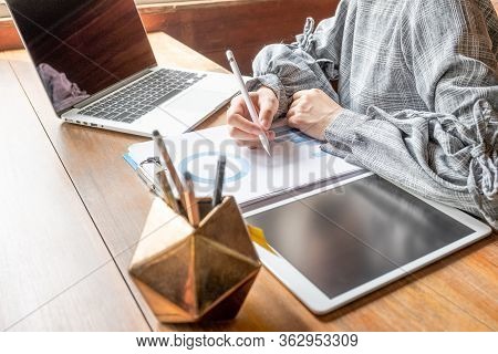 Business Woman Working At Home With Her Laptop And Tablat.