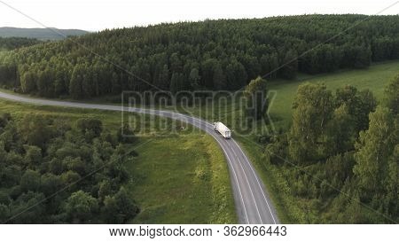Wagon Driving On The Highway Surrounded By Green Trees, Aerial View. Scene. Transport, Logistics Con