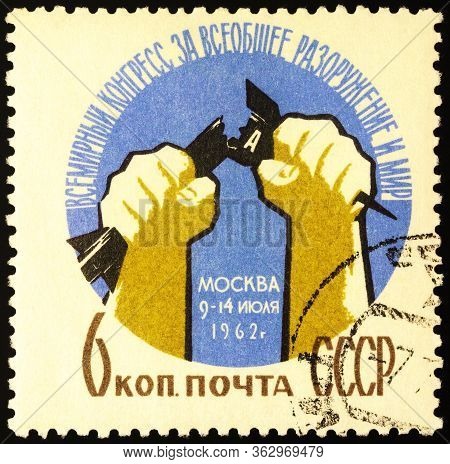 Moscow, Russia - April 24, 2020: Stamp Printed In Ussr (russia), Shows Hands Break Atomic Bomb, Dedi