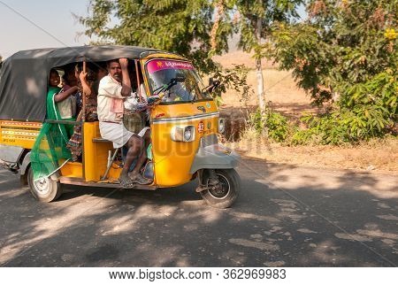 Indian People Travel In Rickshaw Taxi Along The Road Of Puttaparthi Village, India