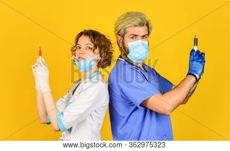 Doctor In Medical Mask Ready To Make Injection. Stop Coronavirus. Virus Infection Injection Vaccine.