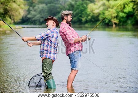 Happy Friendship. Hobby And Sport Activity. Trout Bait. Father And Son Fishing. Two Happy Fisherman 