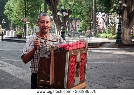 Street Performer Of Organillero Or Cilindrero Organ Grinder Plays The Street Organ In The Zocalo Of 