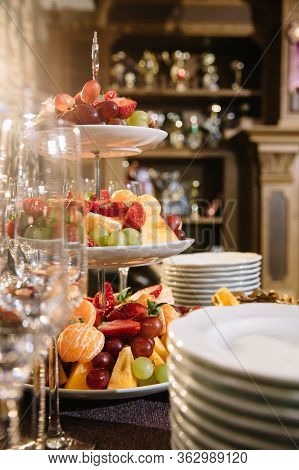 Three-tier Modern Dish With Yellow Brass Plates And A Rod With A Brass Ring Handle For Desserts Or S
