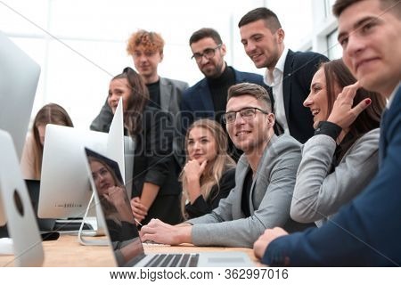 exultant business team looking at the screen of the office computer