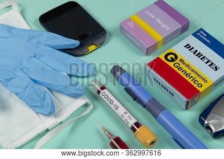Various Elements Of Medicine On A Green Background And A Tube Of Blood Test For Covid-19. Box Write 