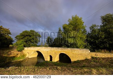 Romanesque bridge of Artigue and river Osse near Larressingle on route to Santiago de Compostela, UNESCO World Heritage Site, departement Gers, France