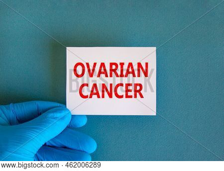 Ovarian Cancer Symbol. White Note With Words Ovarian Cancer, Beautiful Blue Background, Doctor Hand 