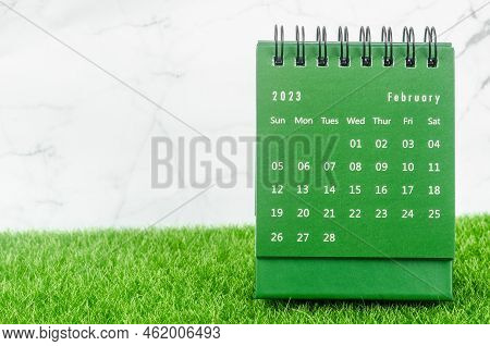 Green February 2023 Monthly Desk Calendar For 2023 Year On Grass.