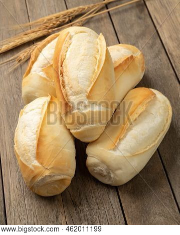French Bread, Salt Bread Or Pistolet Over Wooden Table.
