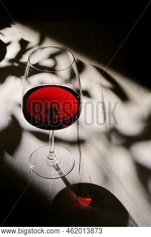 Abstract Shadows, Sunlight And Glass Of Dry Red Wine
