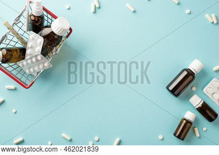 Illness Concept. Top View Photo Of Shopping Cart With Medicines Transparent Brown Bottles Pills Blis