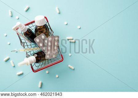 Disease Concept. Top View Photo Of Shopping Cart With Medicines Spray And Syrup Transparent Brown Bo