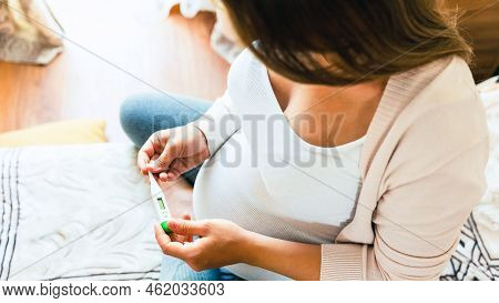 Pregnancy Health Temperature Check. Pregnant Woman Holding Thermometer, Check Fever Flu Temperature.