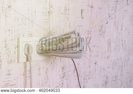 Socket And Switch In The Wall. 100 Is In It. Tariff Growth. Saving Electricity