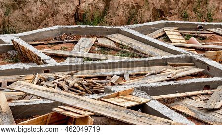 Dismantling The Strip Foundation Formwork At The Construction Site. Dismantling Of Wooden Formwork P