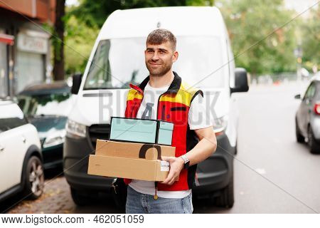 Image Of Delivery Man Holding Parcel Box